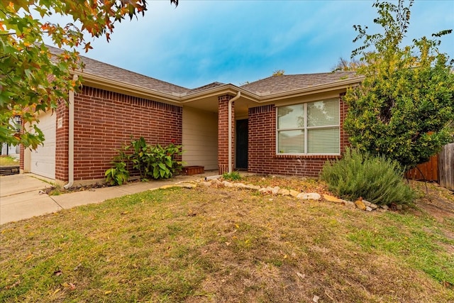 single story home with a front yard and a garage