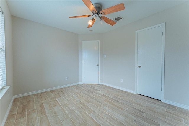 empty room with light hardwood / wood-style flooring and ceiling fan