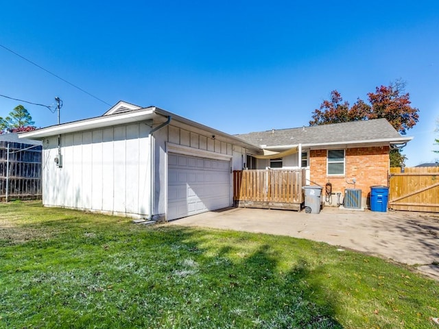 view of front of property with a front yard and a garage