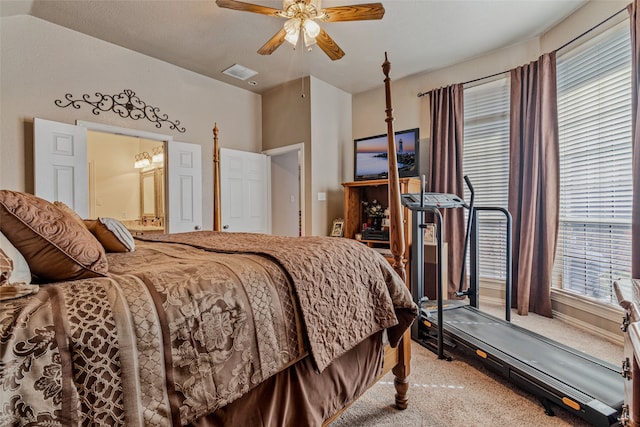 bedroom featuring carpet flooring, ensuite bath, ceiling fan, and lofted ceiling