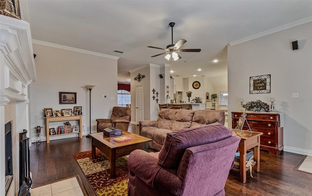 living room featuring dark hardwood / wood-style floors, ceiling fan, and crown molding