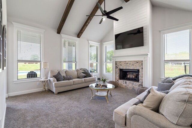 carpeted living room featuring ceiling fan, a fireplace, high vaulted ceiling, and a healthy amount of sunlight