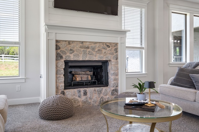 living room with carpet floors and a fireplace