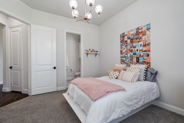 carpeted bedroom with a chandelier and ensuite bath