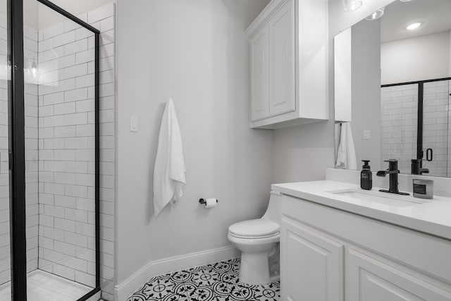 bathroom featuring tile patterned flooring, vanity, toilet, and an enclosed shower