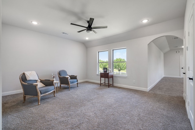 sitting room with ceiling fan, carpet, and vaulted ceiling