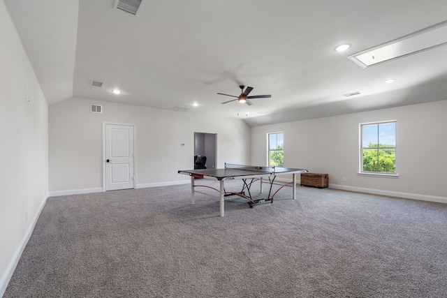 recreation room with ceiling fan, carpet, and vaulted ceiling