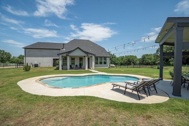 view of swimming pool with a lawn, a patio area, and central AC