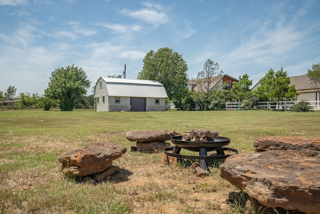 view of yard with an outdoor fire pit