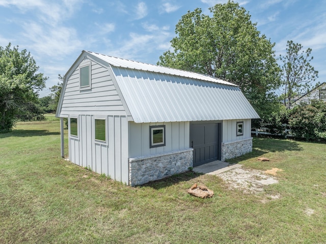 view of outbuilding featuring a lawn