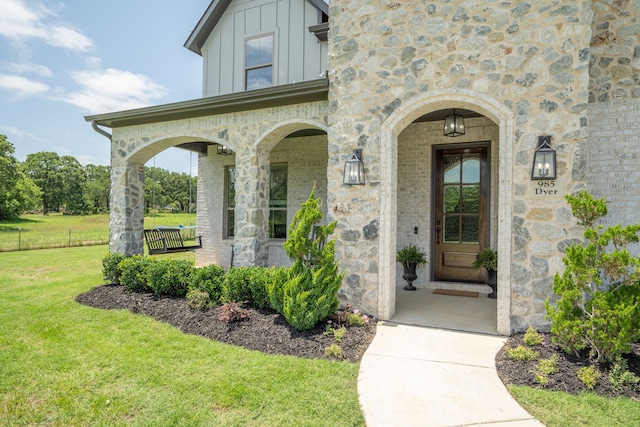 property entrance with a lawn