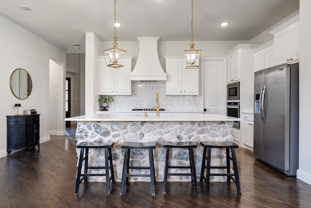 kitchen featuring white cabinetry, dark hardwood / wood-style flooring, stainless steel appliances, and custom exhaust hood