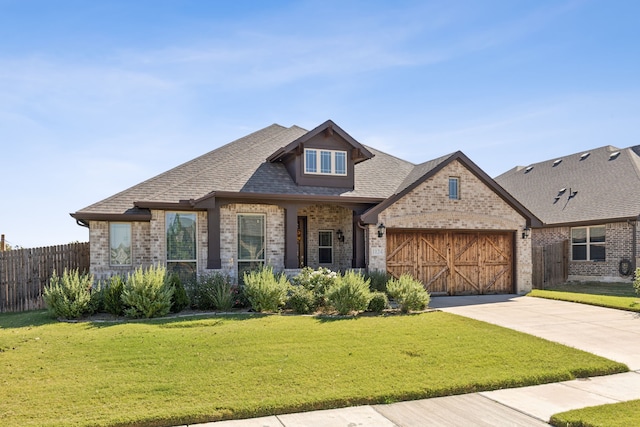 view of front facade with a garage and a front lawn