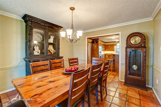 dining room with a textured ceiling, crown molding, and a chandelier