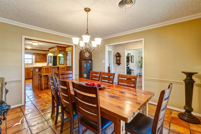 dining room featuring a textured ceiling, an inviting chandelier, and ornamental molding