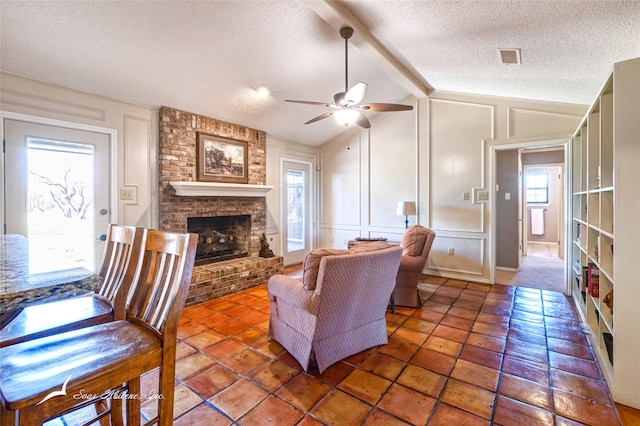 living room featuring a textured ceiling, plenty of natural light, and vaulted ceiling