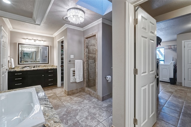 bathroom with a shower, vanity, a textured ceiling, and ornamental molding