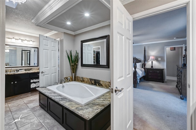 bathroom with a washtub, vanity, a textured ceiling, and crown molding