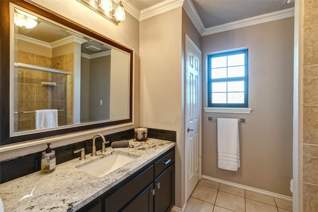 bathroom featuring vanity, tile patterned floors, an enclosed shower, and ornamental molding