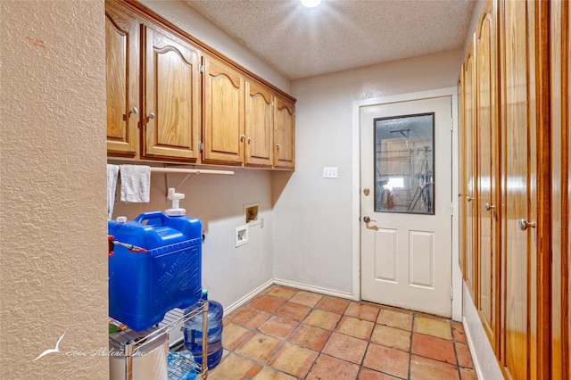 laundry area with cabinets, hookup for a washing machine, and a textured ceiling