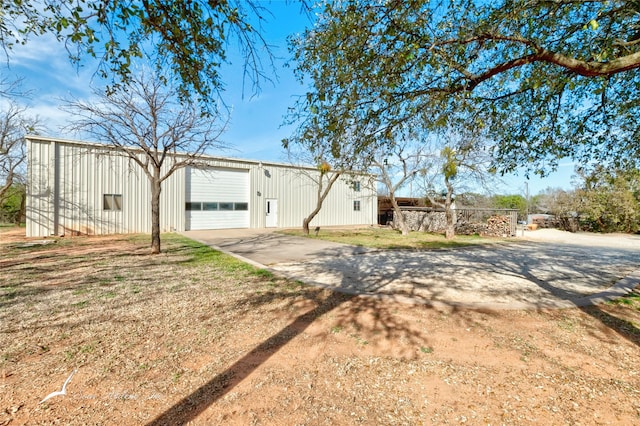 exterior space with an outbuilding and a garage