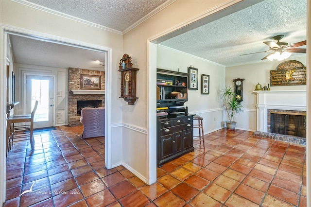 hallway with a textured ceiling, tile patterned floors, and ornamental molding