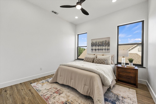 bedroom with hardwood / wood-style flooring and ceiling fan