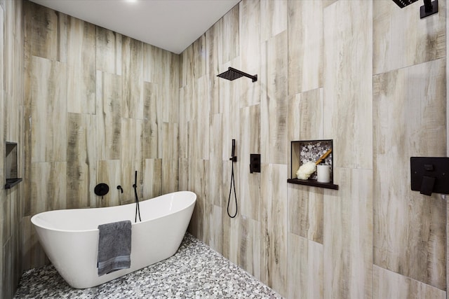 bathroom featuring separate shower and tub and tile walls