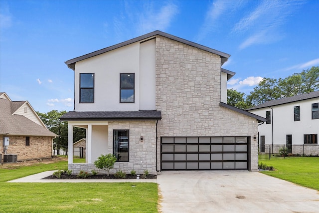 view of front of house featuring a garage, central air condition unit, and a front yard