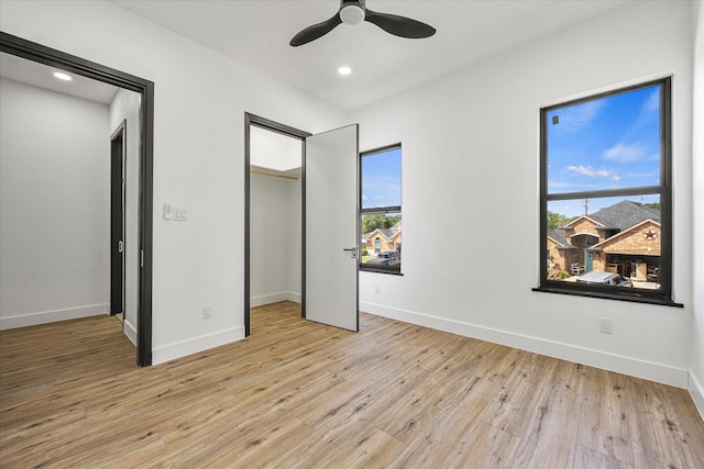 unfurnished bedroom with ceiling fan, a closet, and light hardwood / wood-style flooring