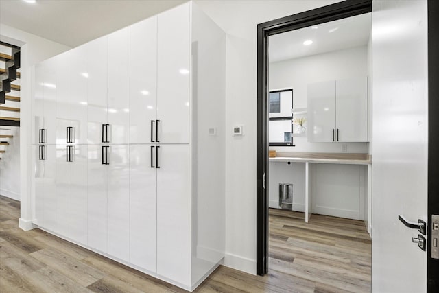 kitchen with white cabinets and light wood-type flooring