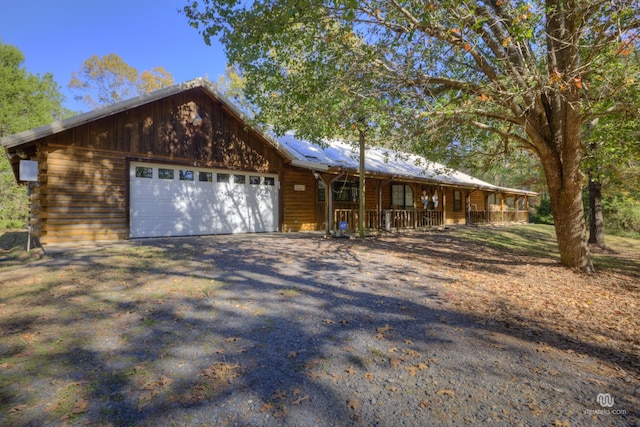 view of front of house with a porch and a garage