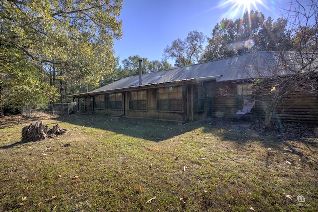 rear view of property with a lawn