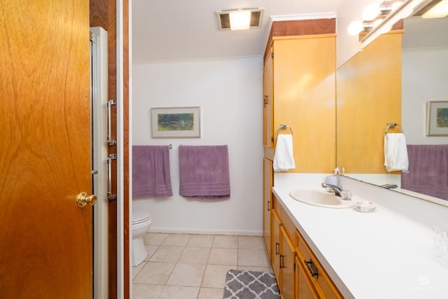 bathroom with vanity, crown molding, tile patterned floors, and toilet