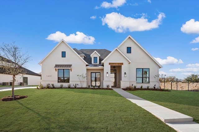 modern farmhouse style home with a front yard