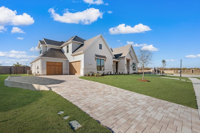 view of front of house featuring a garage and a front yard