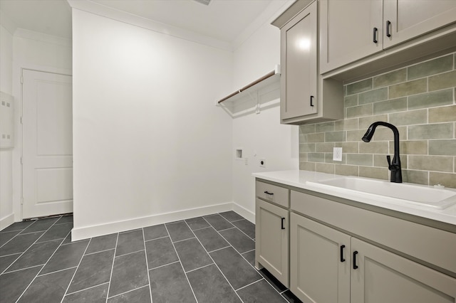 washroom featuring hookup for a washing machine, crown molding, electric dryer hookup, and sink