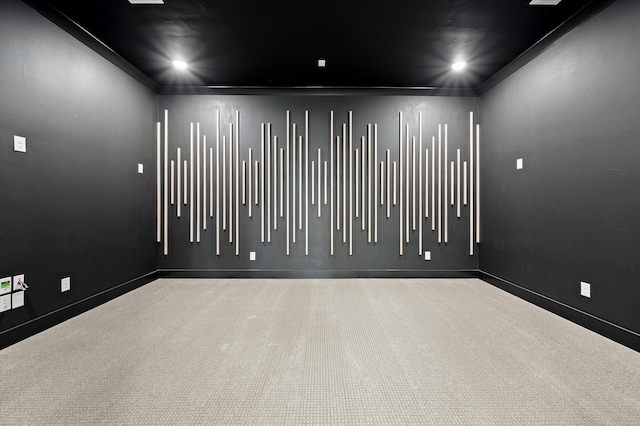 unfurnished room featuring ornamental molding and light colored carpet