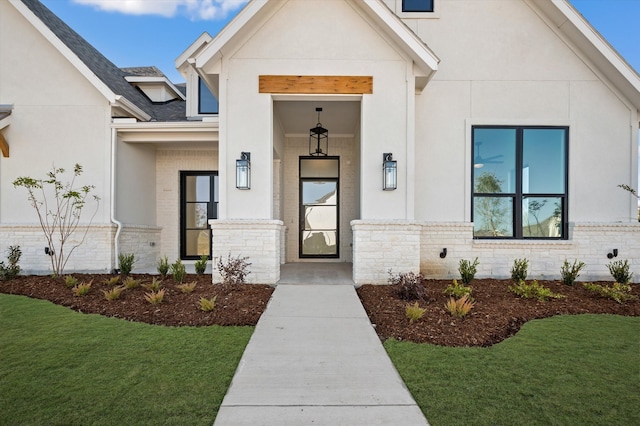 entrance to property featuring a lawn