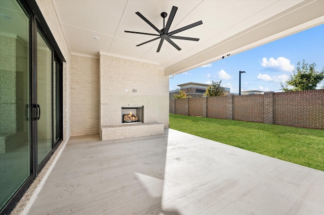 view of patio / terrace with an outdoor brick fireplace and ceiling fan