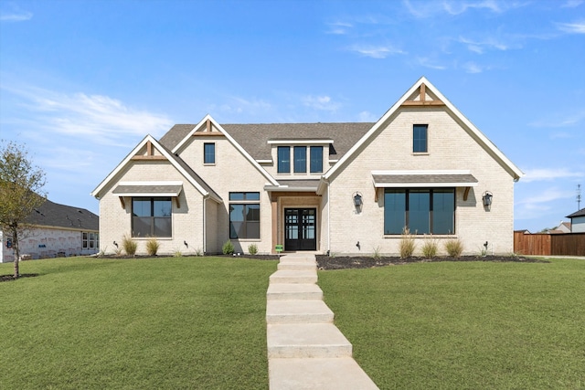 view of front of property featuring french doors and a front lawn