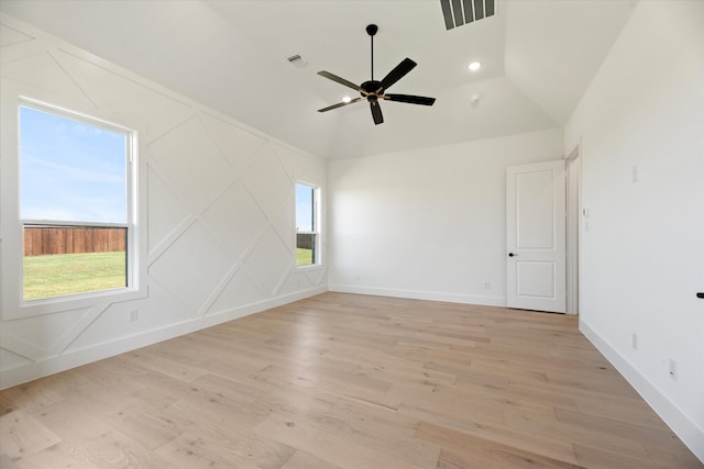 empty room with ceiling fan, light hardwood / wood-style floors, and high vaulted ceiling