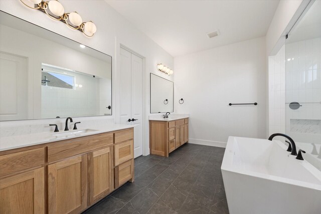 bathroom with vanity and separate shower and tub