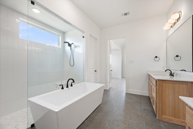 bathroom with tile patterned floors, vanity, and shower with separate bathtub