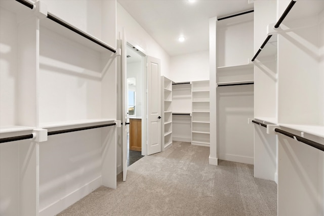 spacious closet with light colored carpet