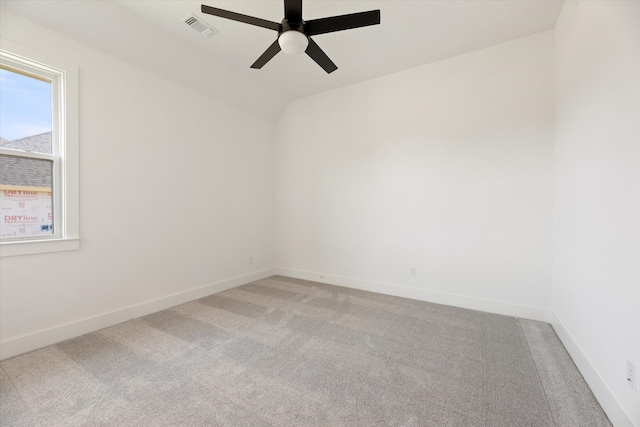 carpeted spare room with ceiling fan and lofted ceiling