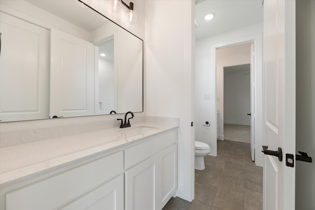 bathroom featuring tile patterned flooring, vanity, and toilet