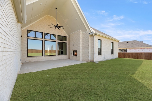 rear view of house featuring a lawn and a patio area