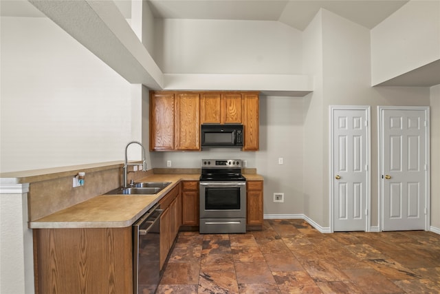 kitchen with kitchen peninsula, stainless steel appliances, high vaulted ceiling, and sink