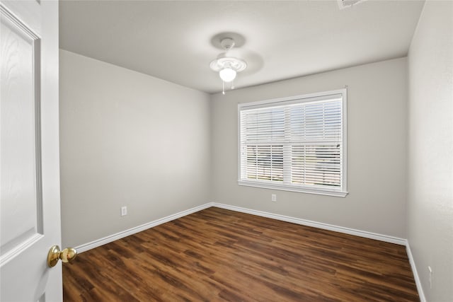 unfurnished room with dark hardwood / wood-style flooring and ceiling fan